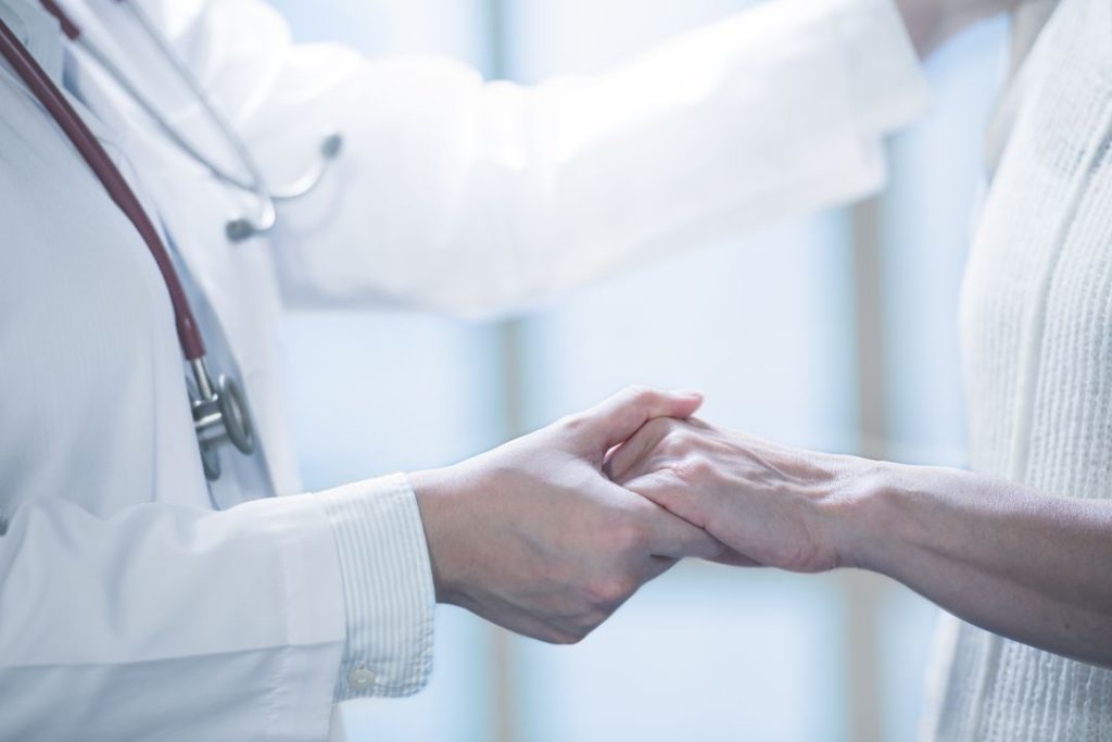 a doctor shaking hands with a patient
