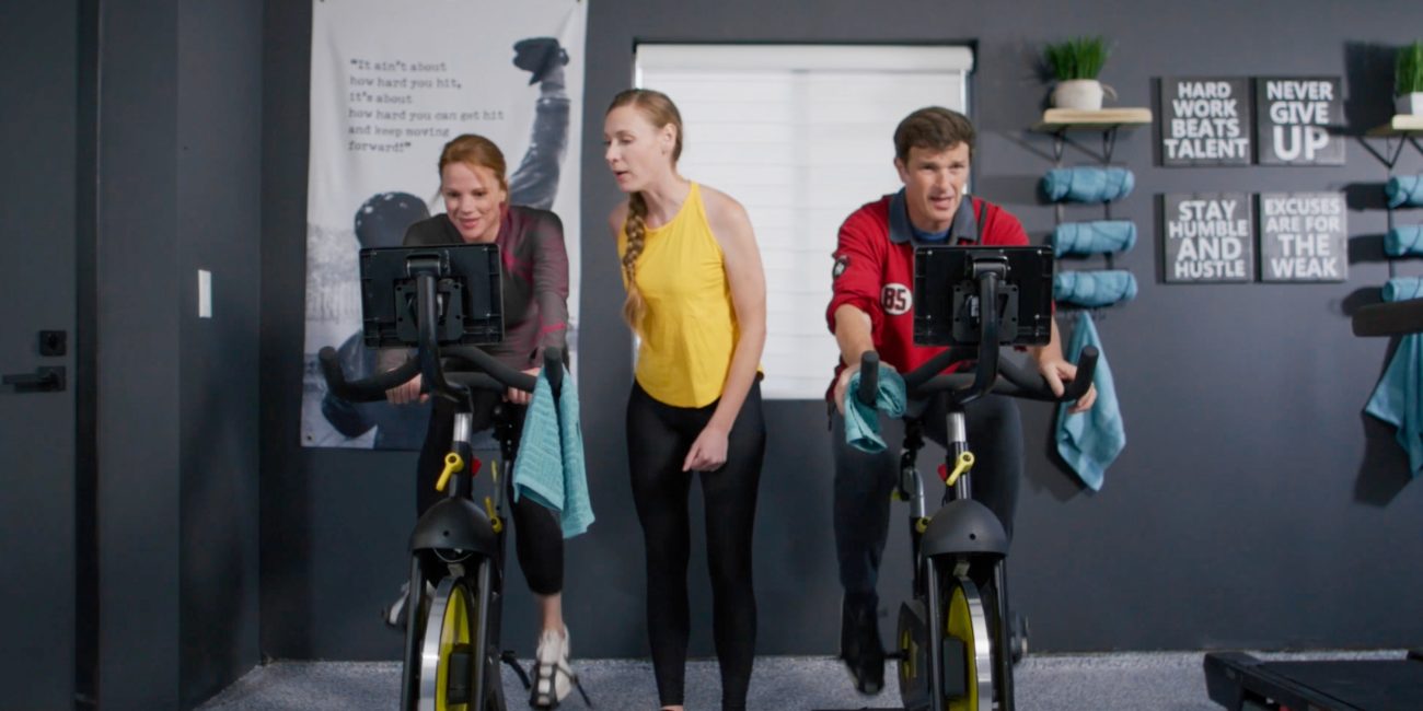 two people on exercise bikes with an instructor at Uplift Recovery Center