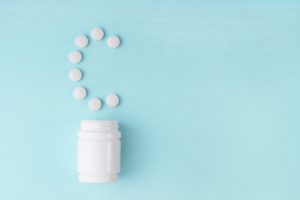 pills from a pill bottle in the shape of a "c"