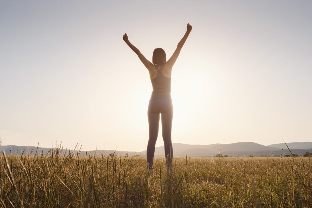 a woman celebrating addiction recovery after inpatient detox