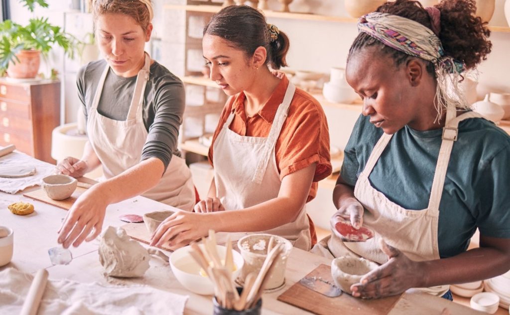 three women making clay bowls to show the power of art as therapy for addiction