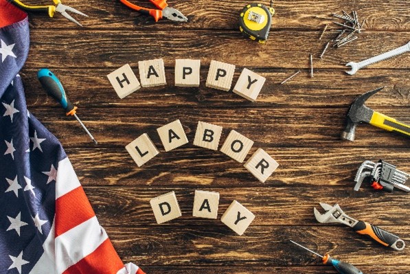 block spelling out "happy Labor Day" on a table surrounded by tools