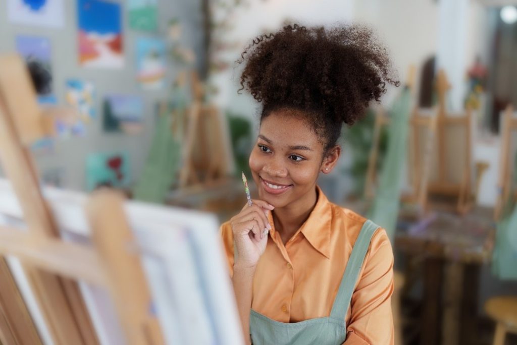 a woman painting to show the power of art as therapy for addiction