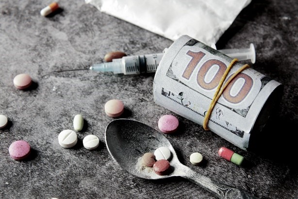 drugs and money all rolled into one highlighting the alarming statistics about addiction