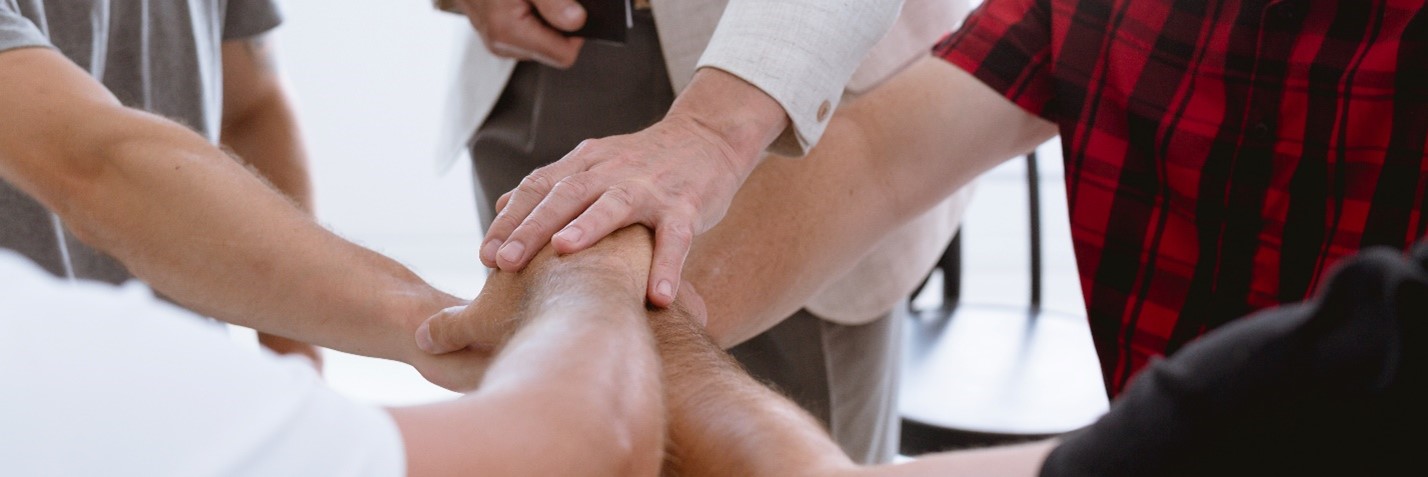 People with hands in a circle emphasizing the benefits of dual diagnosis treatment centers