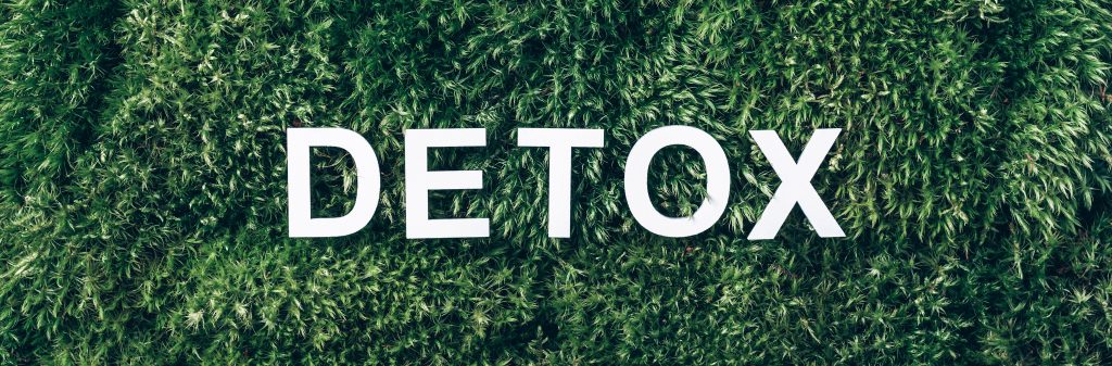 the word "detox" spelled out on grass, signifying the importance of inpatient detox