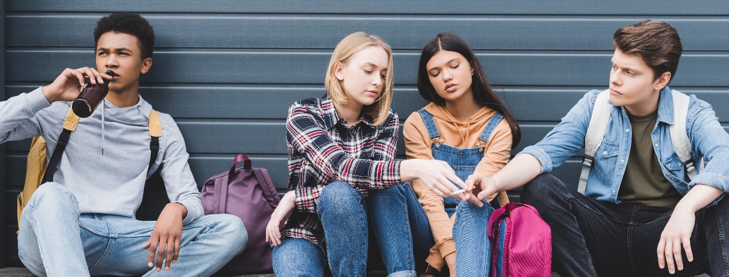 kids gathered together smoking and drinking. Its important to prevent drug addiction in adolescents.
