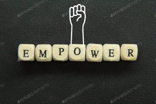 the word "empower" spelled out on blocks with a hand raised in triumph, showing the power of National Recovery Month