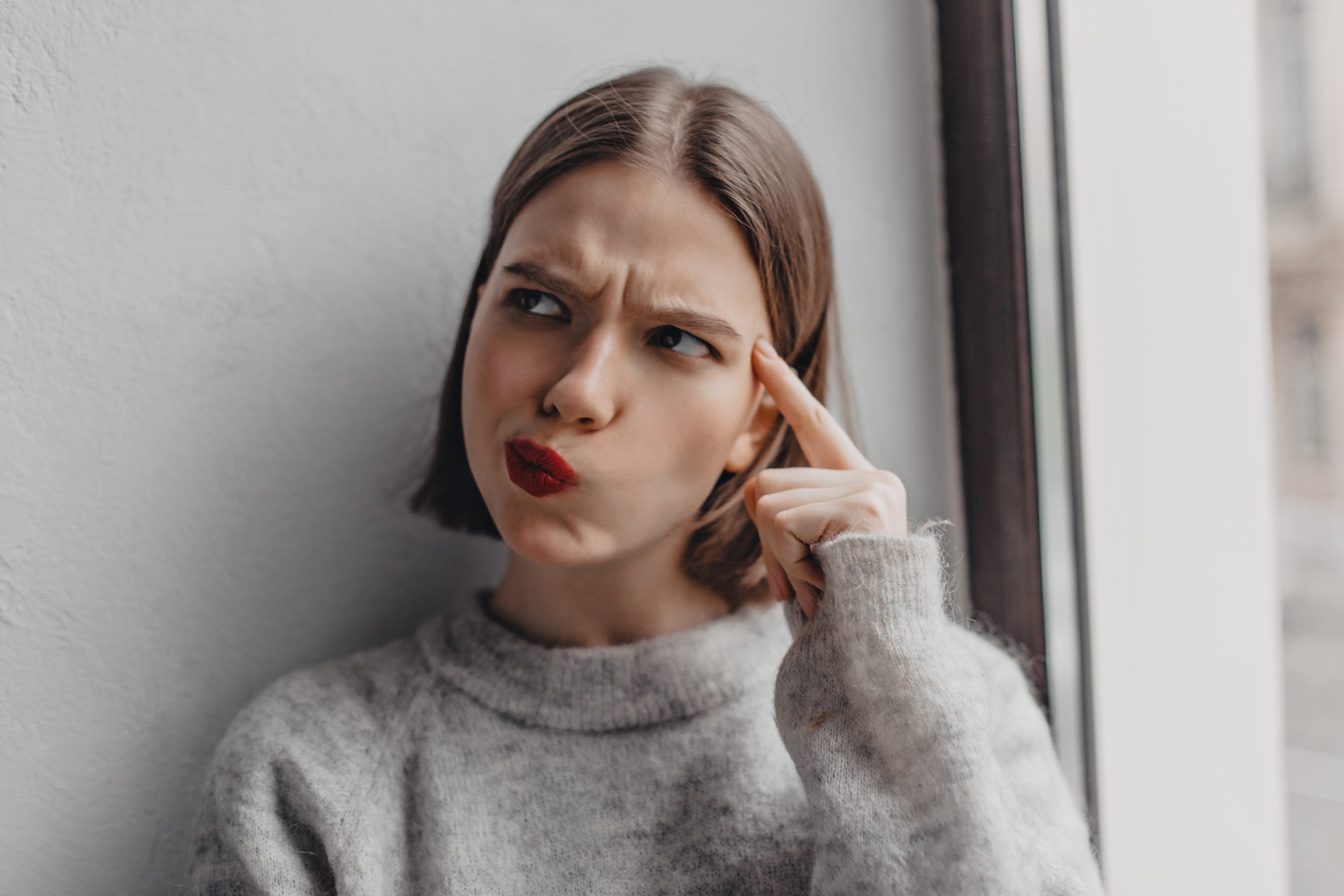a woman deep in thought pondering the difference between opiates and opioids