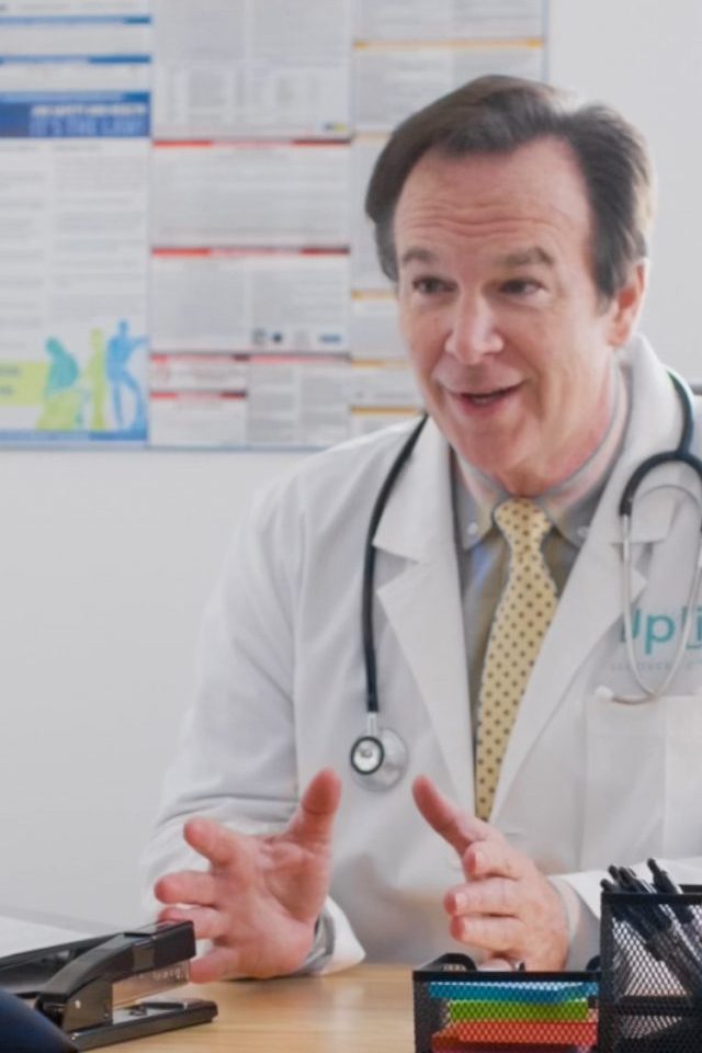 Doctor at Uplift Recovery talking and gesturing to someone off screen