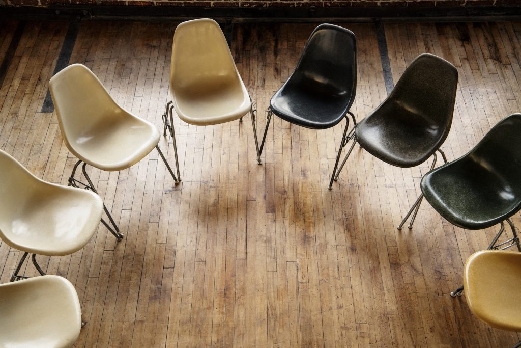 a room full of empty chairs, signifying the idea of how to get an alcoholic to go to rehab is difficult
