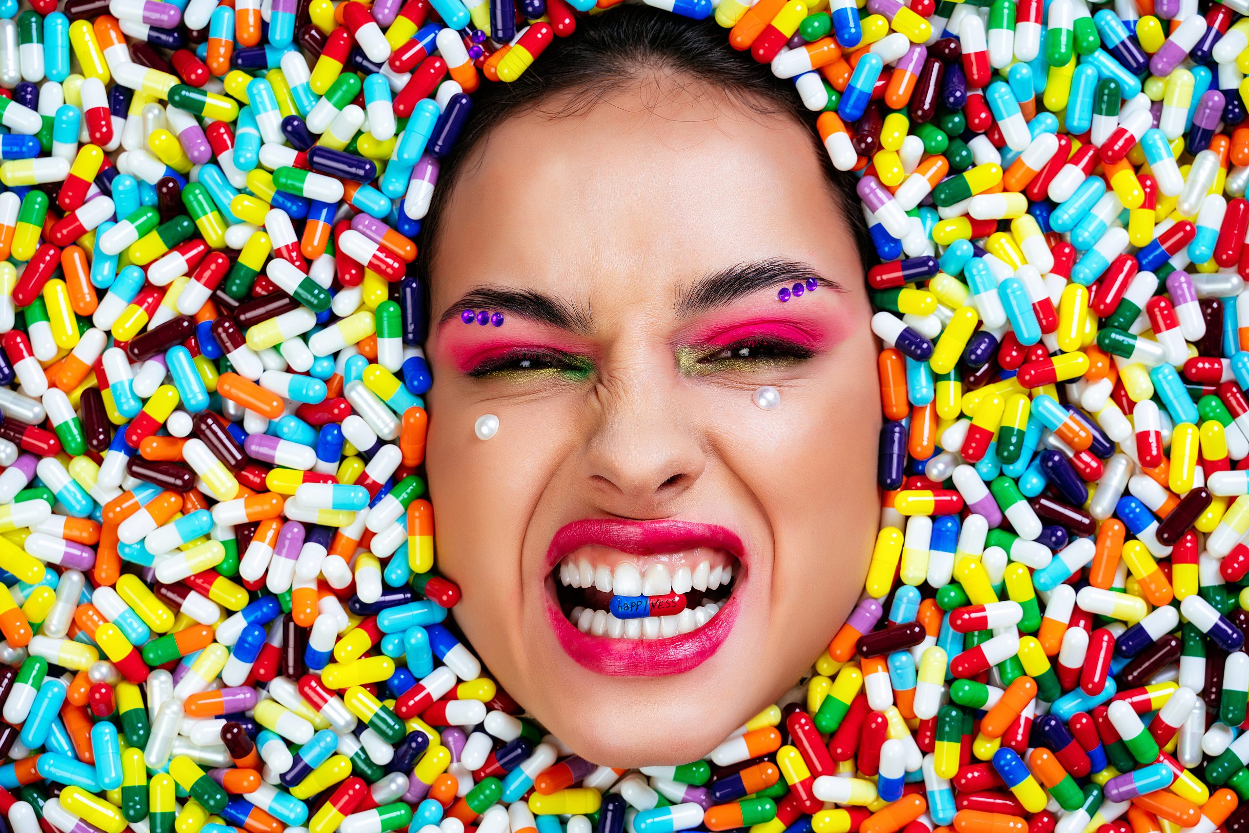 A woman sunk inside pills and capsules, symbolizing her need for an adrenaline rush