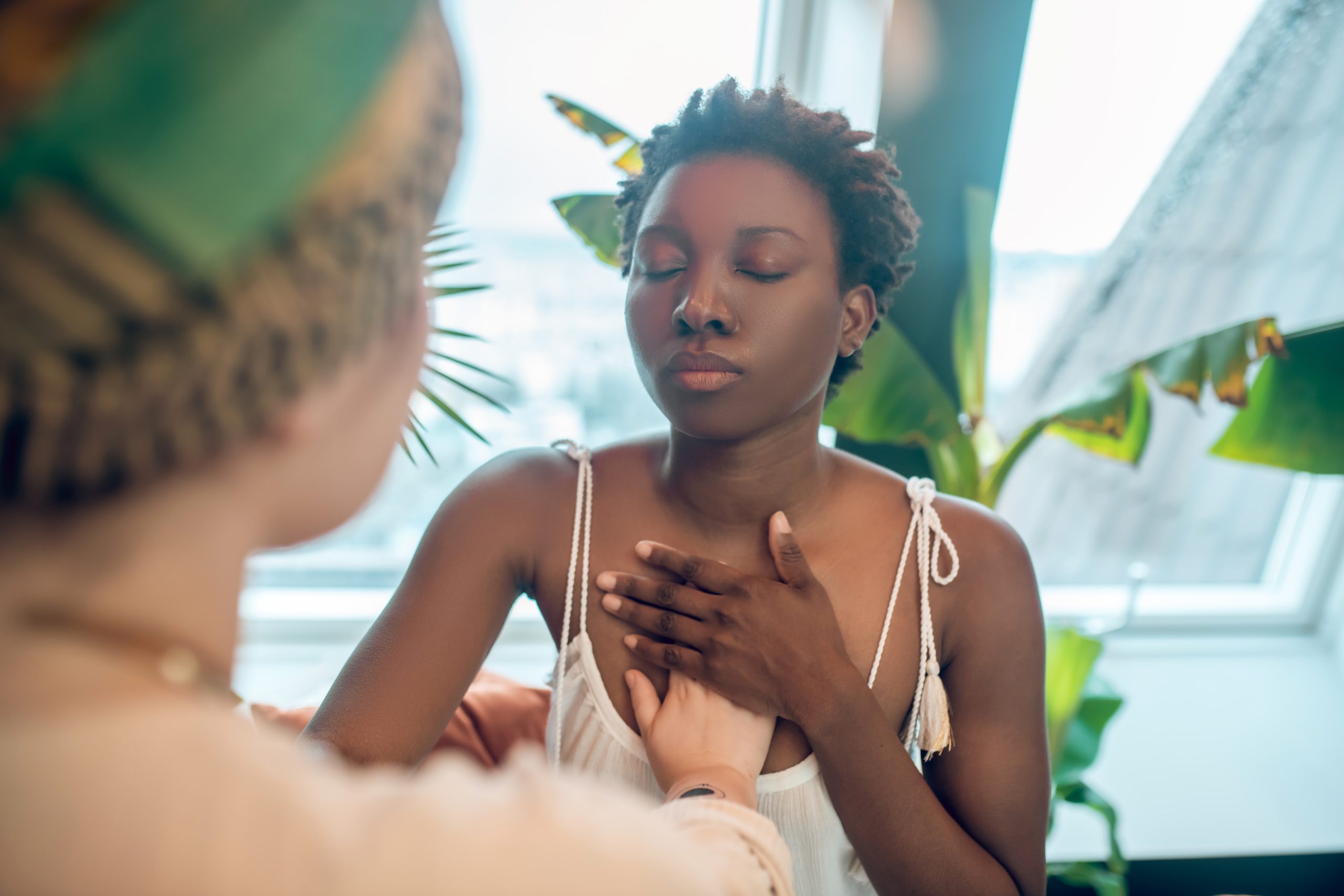 a healer working with a black woman on National Self-Care Day