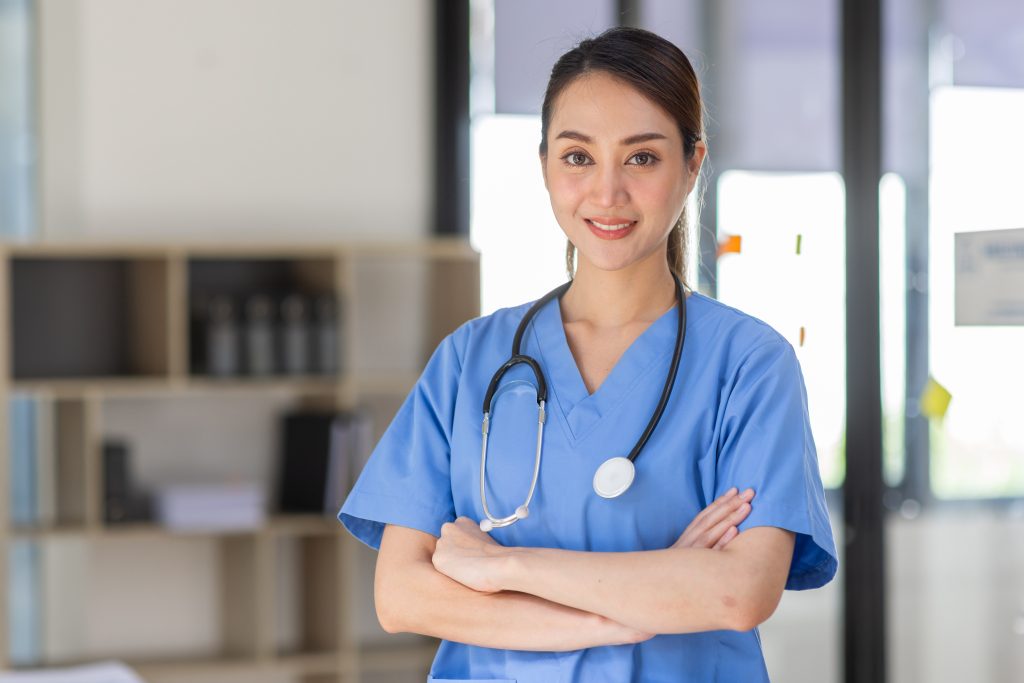 an addiction nurse with her arms folded, smiling at us