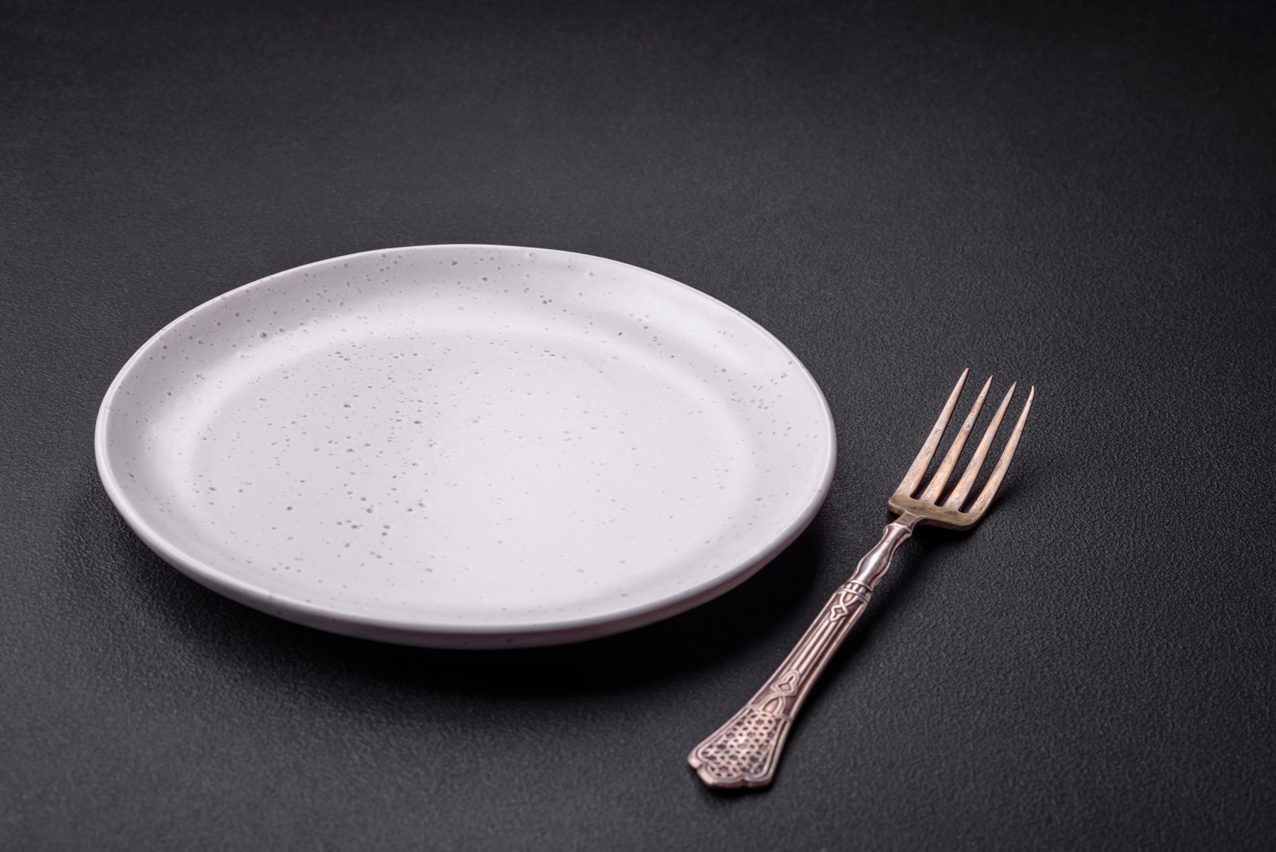 an empty plate and fork, symbolizing an eating disorder and addiction