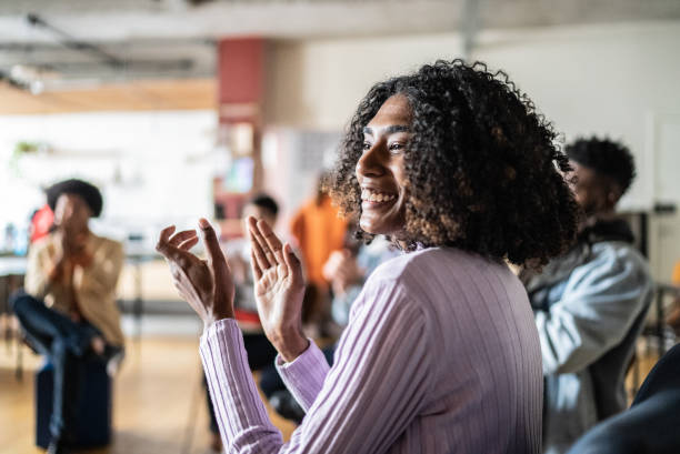 a woman clapping her hands as she congratulates someone on their sobriety