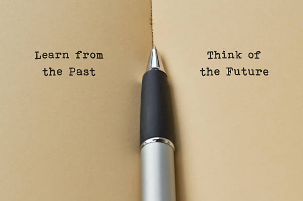 pen seperating the sides of paper, one side reads "learn from the past" and the other reads "think of the future" to highlight Positive Thinking Day