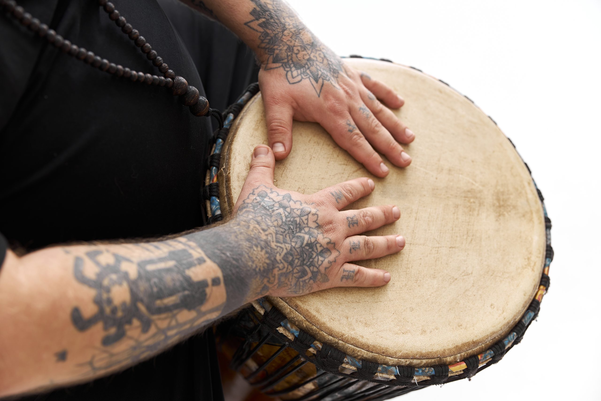 a man playing the drum as part of experiential activities for group therapy